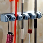 ⁦حامل مكانس خماسي متعدد الاستخدامات لتنظيم أدوات التنظيف، تصميم جداري قوي يوفر مساحة،بجودة عالية يناسب المنزل والمطبخ والحمام⁩ - الصورة ⁦5⁩